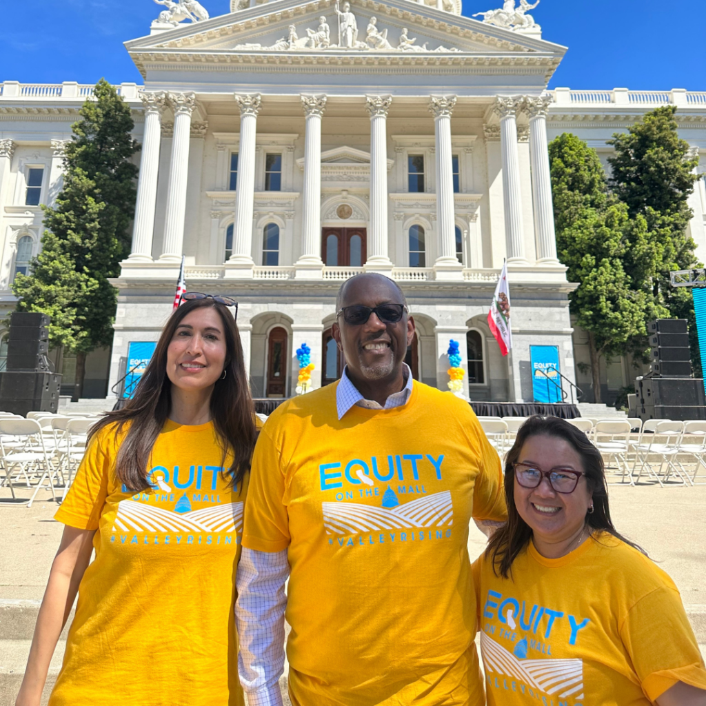 Chet. P. Hewitt pictured at The Center's 2023 Equity on the Mall with Reyna Villalabos, Managing Director of the San Joaquin Valley Health team and Kaying Hang, President of The Center 